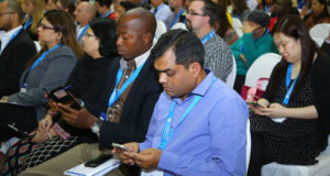 Cambridge Schools Conference delegates engaging in discussion on the conference app.
